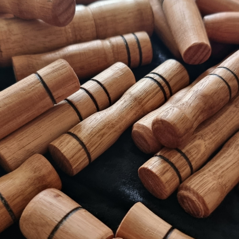 A stack of Wooden Sensory Sticks Set.