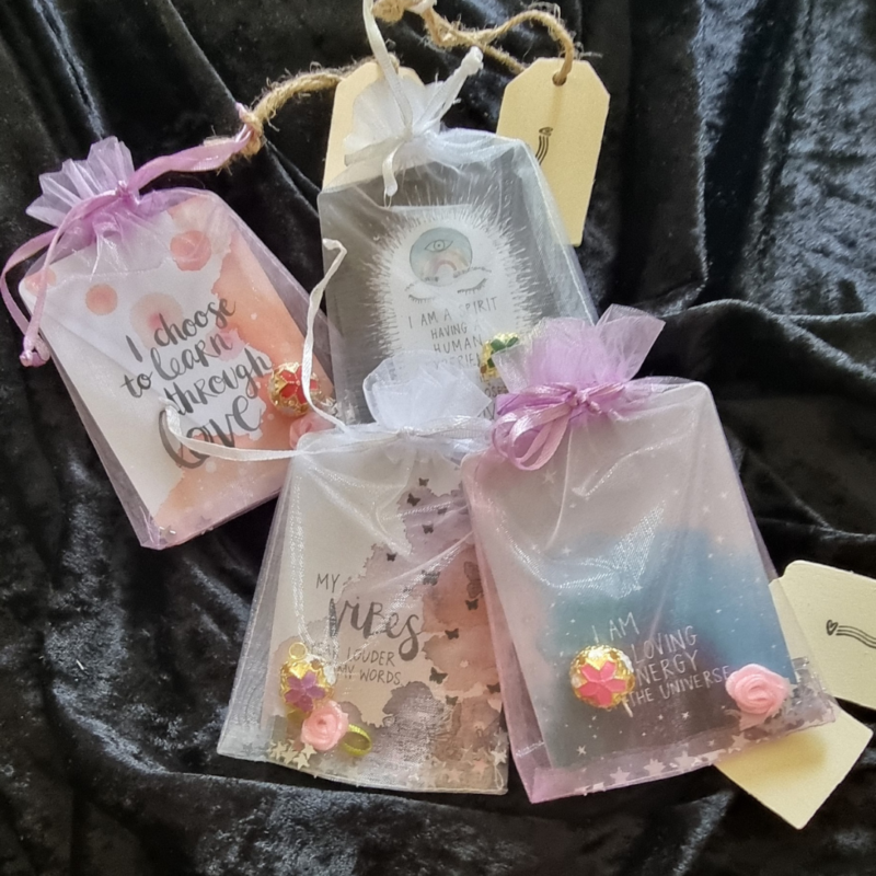A set of Little Bags of Positivity - Lilac with tags on them.