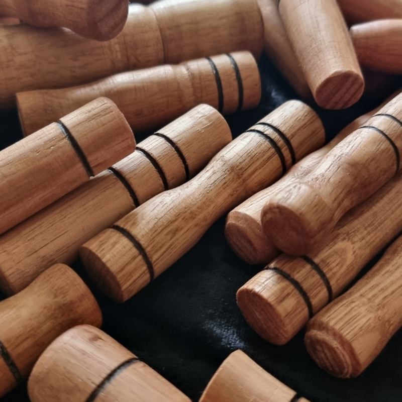A stack of Wooden Sensory Sticks Set.