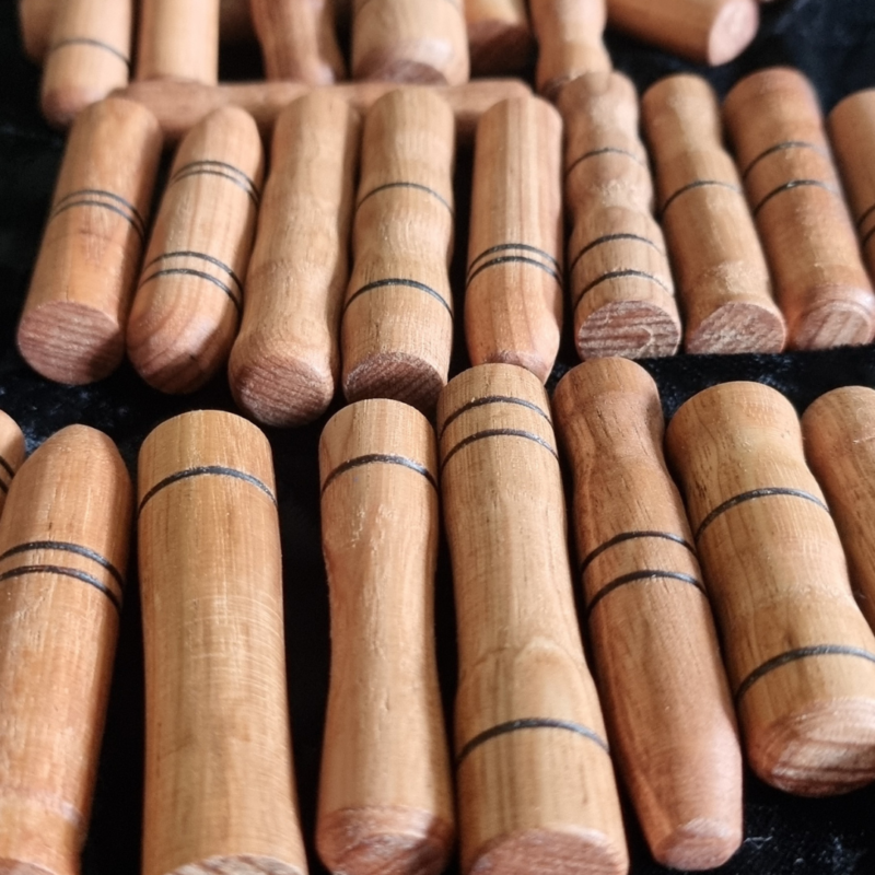 A set of Wooden Sensory Sticks are arranged on a table.