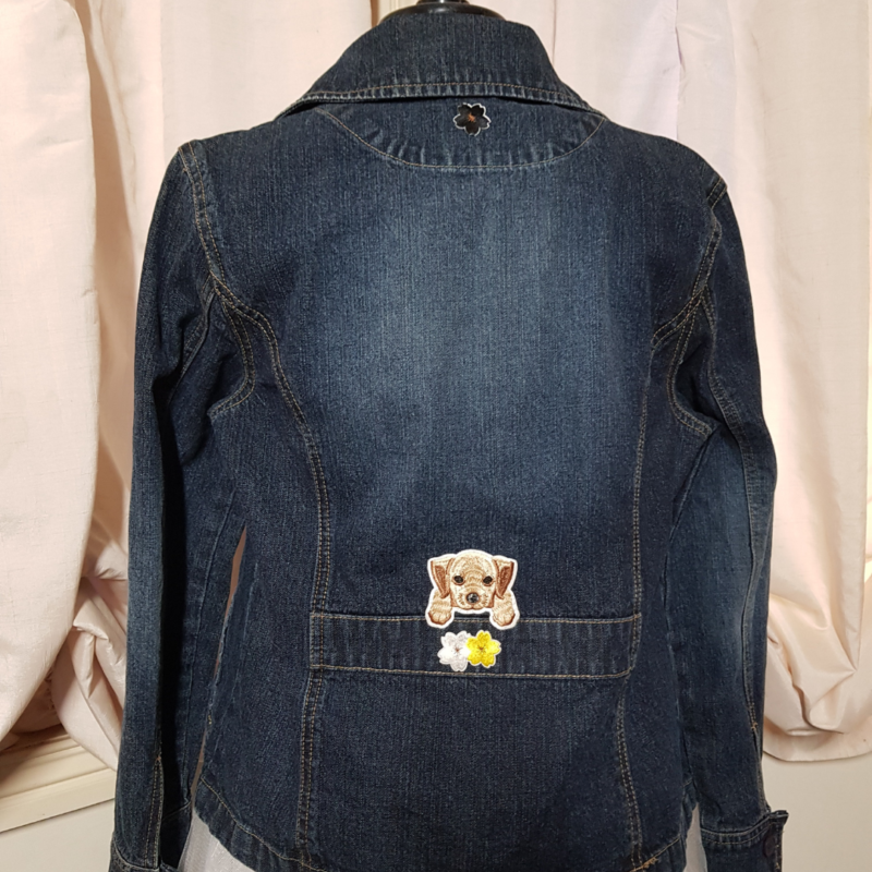 A Puppy Flower Power Upcycled Denim Jacket with a teddy bear on the back.