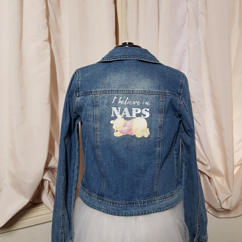 An "I Believe in Naps" upcycled denim jacket with a teddy bear on it.