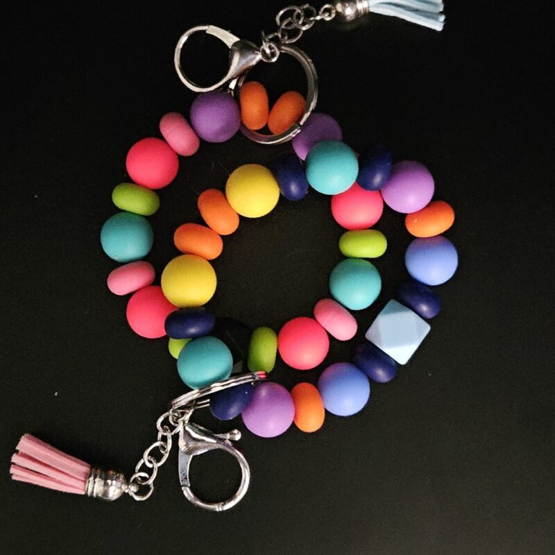 A colorful beaded bracelet with a Wooden Stretchy Key Wristlet - Keep your Keys Handy Copy.