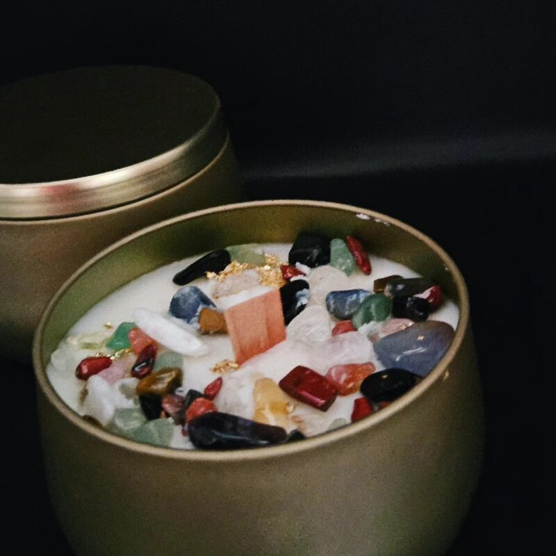 A gold tin filled with stones and crystals.